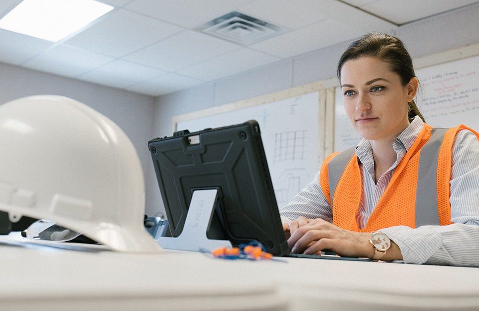 A female construction worker on a computer