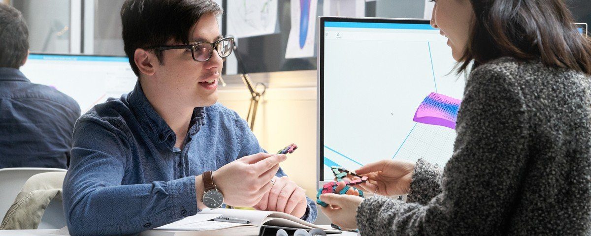 Man and Woman discuss parts and design for HP Jet Fusion 3D Printer