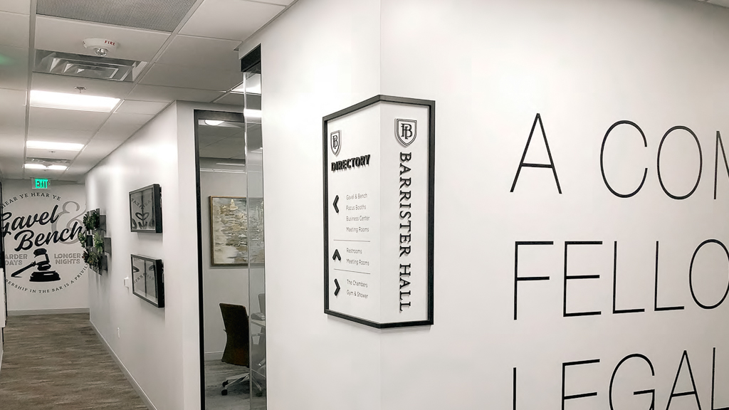 Wayfinder directional signage installed on the corner of a wall.